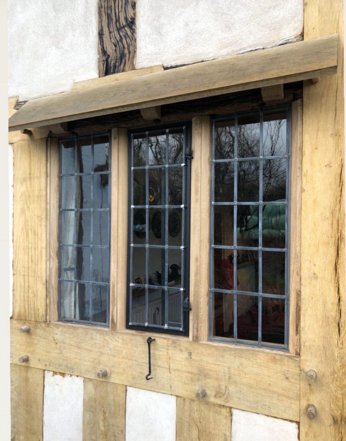 Oak-framed leaded casement windows on a timber-frame building