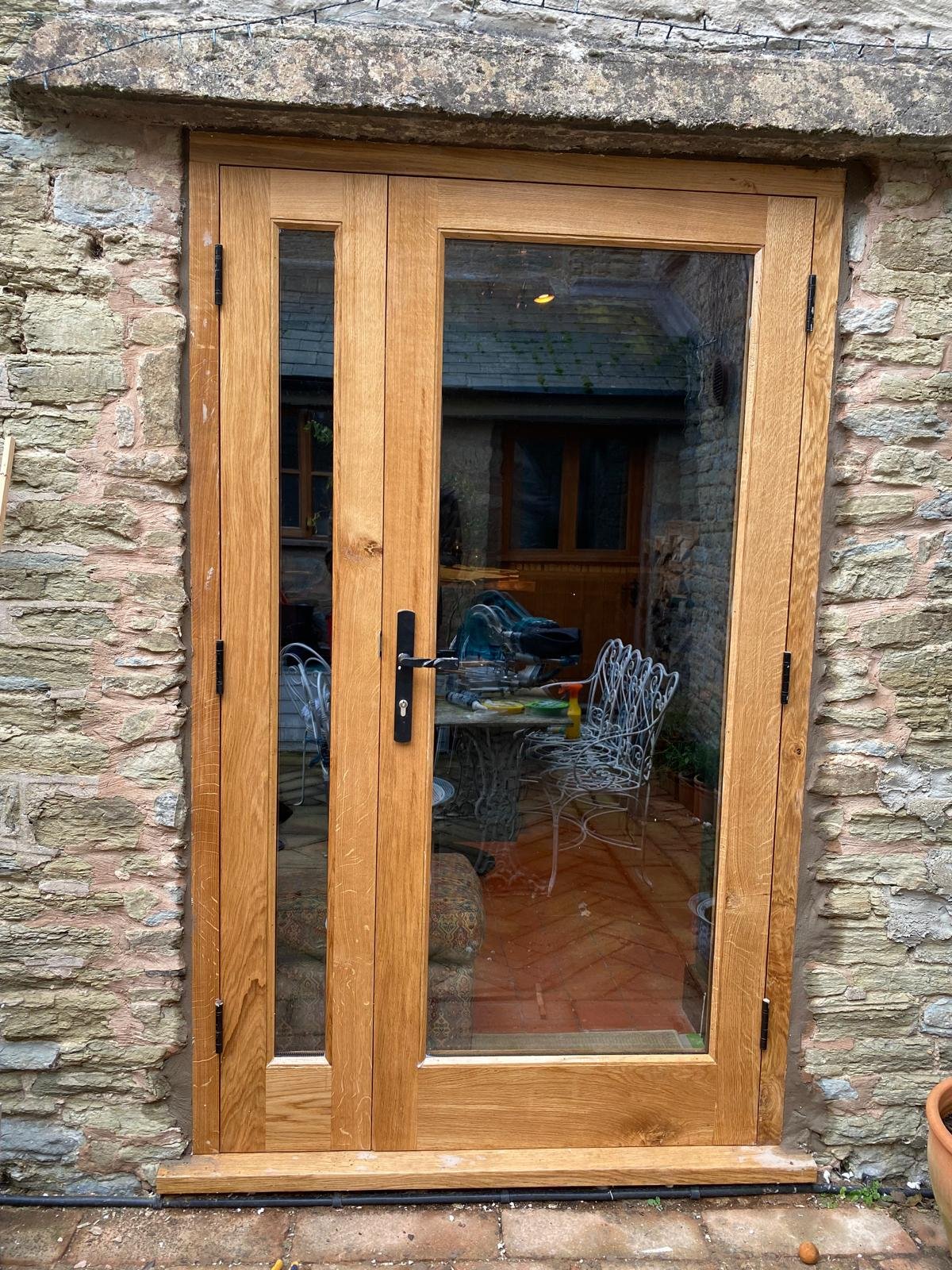 Oak French doors in stone