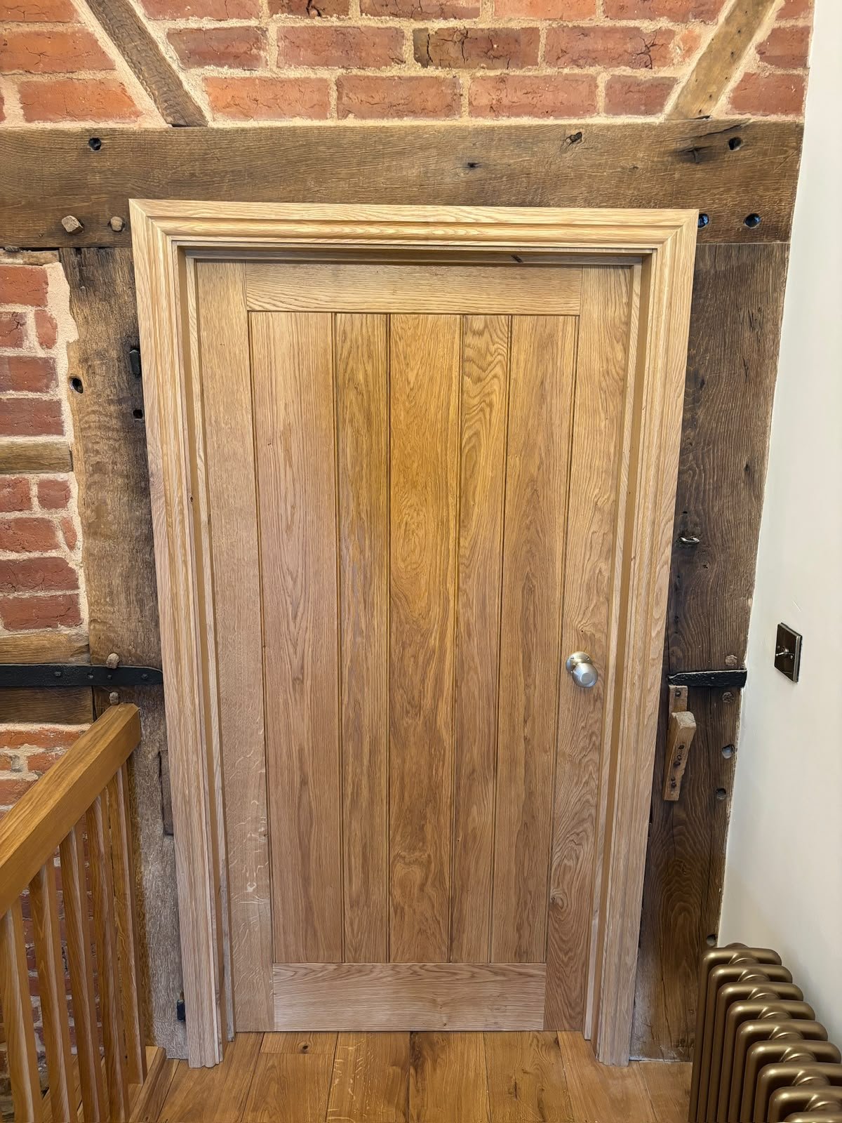 Solid oak internal door on a timber-framed landing
