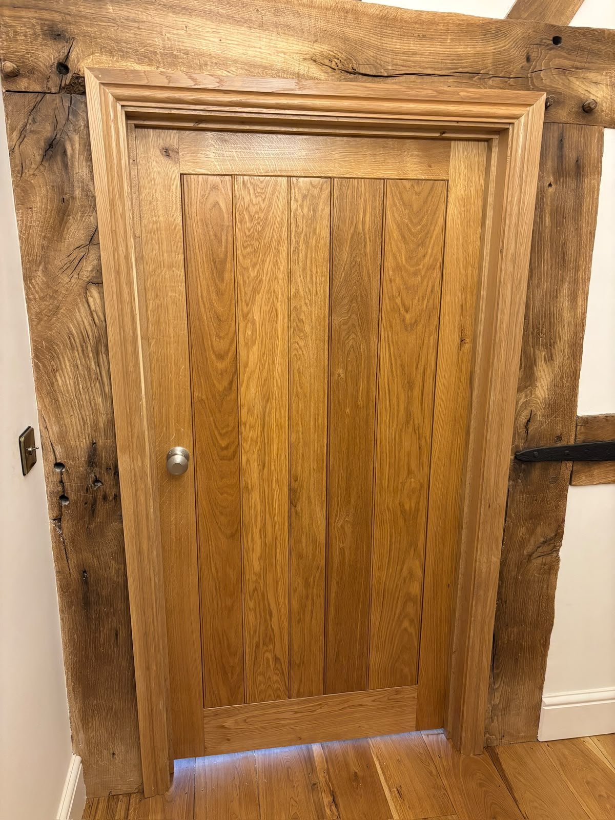 Solid oak internal door set within exposed oak beams